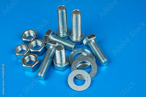 metal bolts and nuts on a blue background
