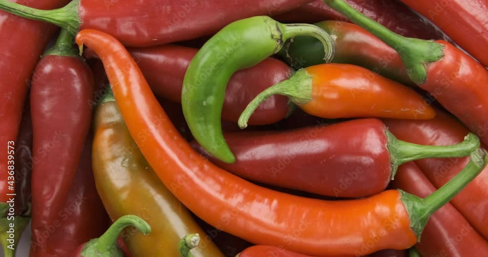 Rotation and zoom of the hot peppers heap. Vegetables background. Top view. Rotation and zoom of the hot peppers heap. Vegetables background. Top view.