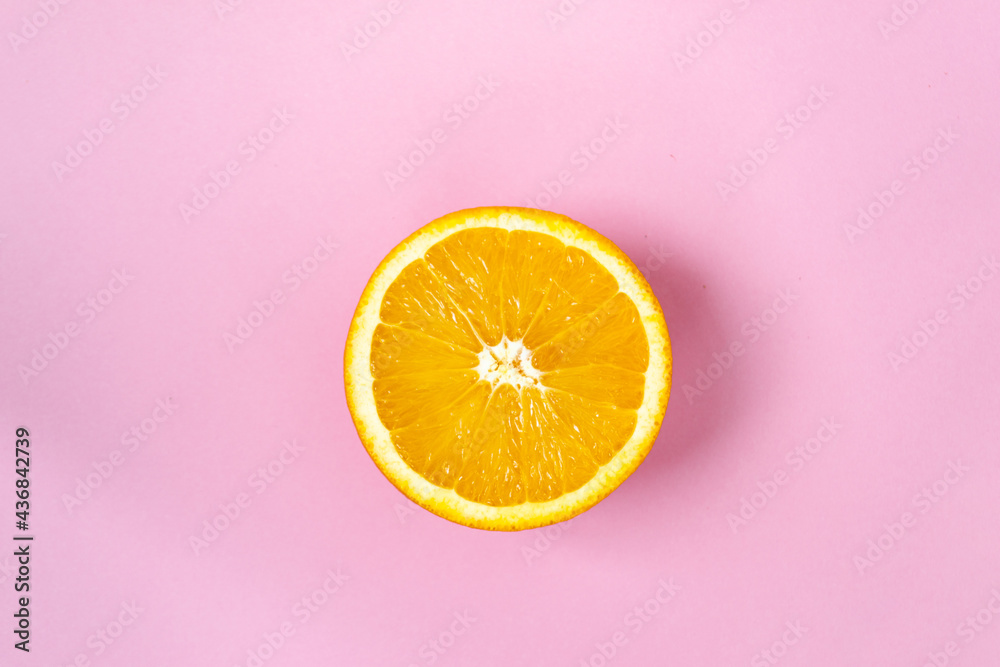 Top view of one orange round fruit on bright blue background. Rich citrus texture. Copy space Top view of one orange round fruit on bright blue background. Rich citrus texture. Copy space
