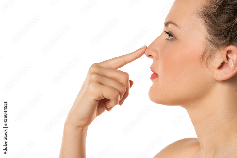 woman touching her nose woman touching her nose