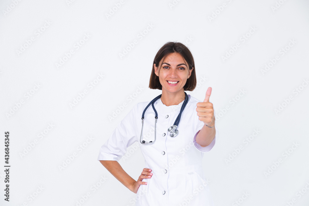Female doctor in lab coat on white background isolated, confident smile show thumb up Female doctor in lab coat on white background isolated, confident smile show thumb up