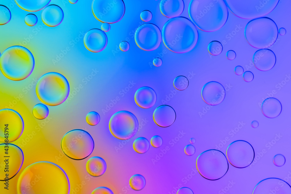 Vivid neon background with bubbles. Colorful abstract backdrop with bright gradients on blobs. Blue, yellow and pink overflowing colors.