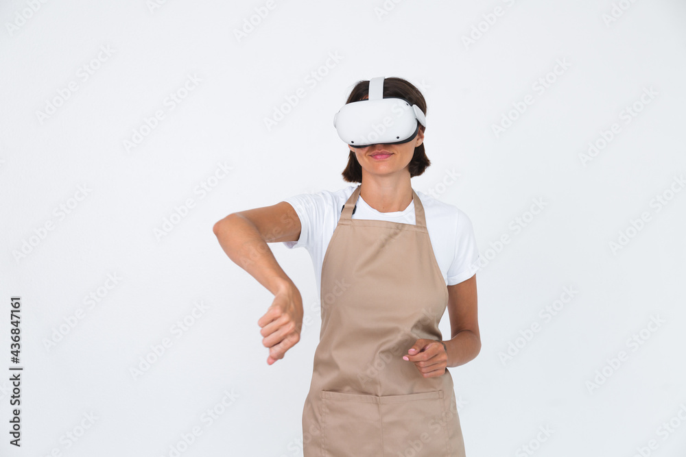 Housewife in apron isolated on white background in vr glasses cooking making dinner play games