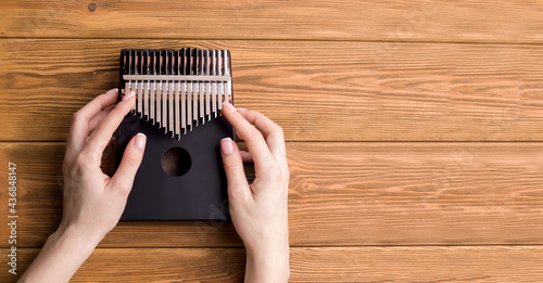 Kalimba musical instrument on a wooden background. Copy space. Banner