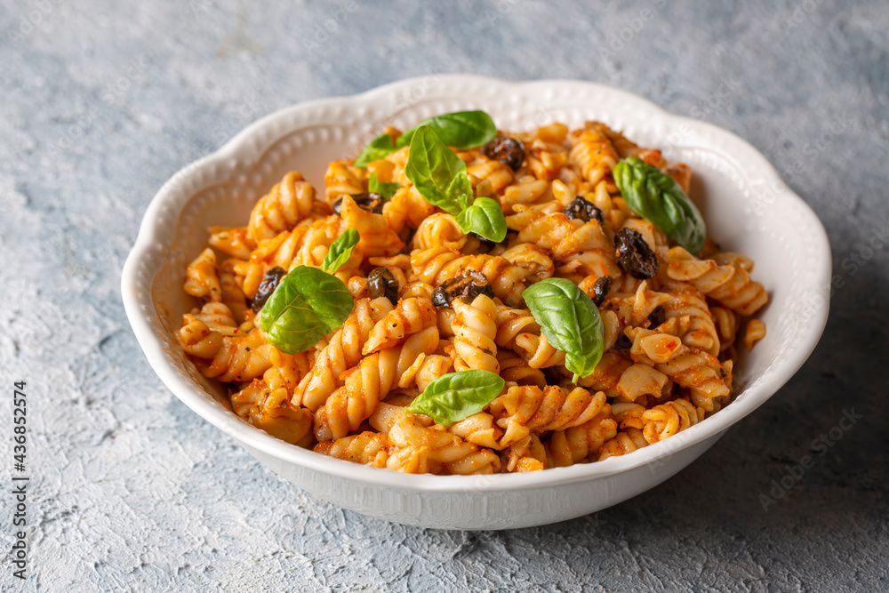 Basil leaves on pasta with arabiata sauce Basil leaves on pasta with arabiata sauce