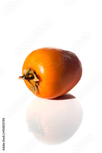 Persimmon fruit isolated on white background with reflection.