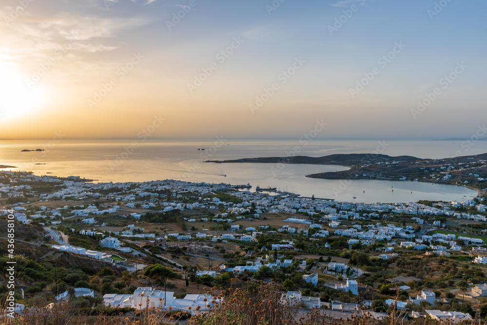 Golden hour panorama view   of the   of parikia village with the traditional white houses in Paros island, Greece.