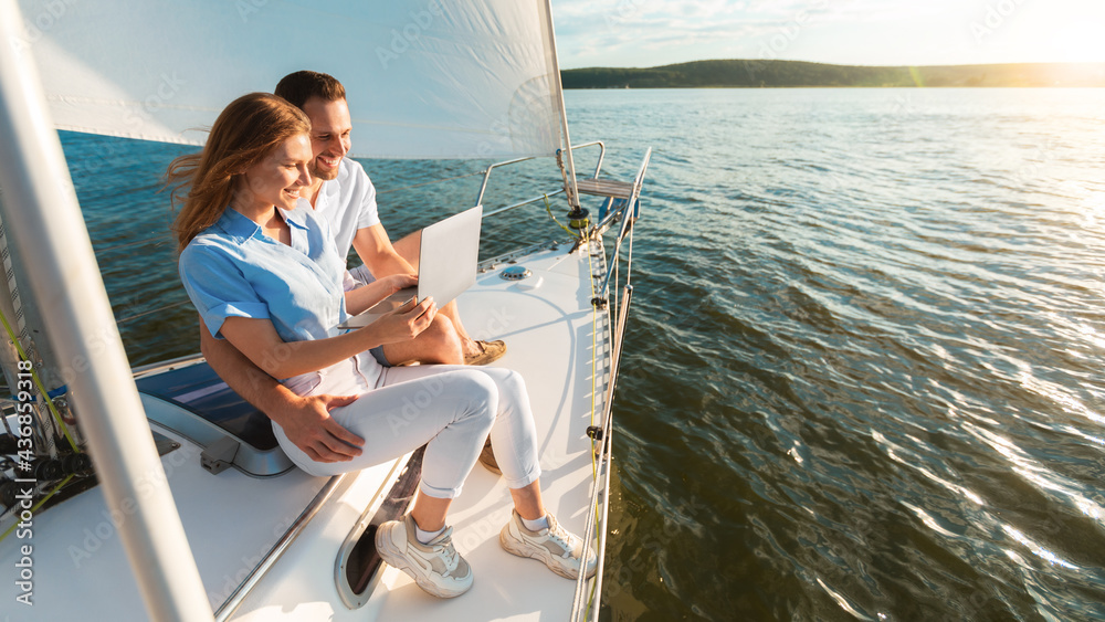 Happy Couple Using Laptop Sitting On Yacht, Panorama