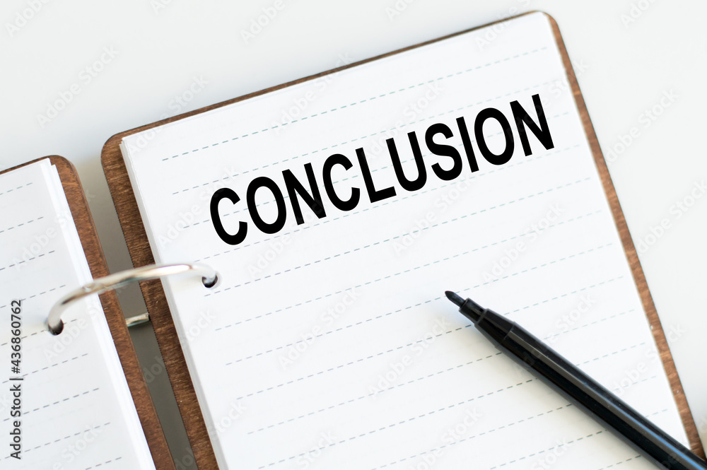 Conclusion inscription on a notebook on the table. business concept Conclusion inscription on a notebook on the table. business concept