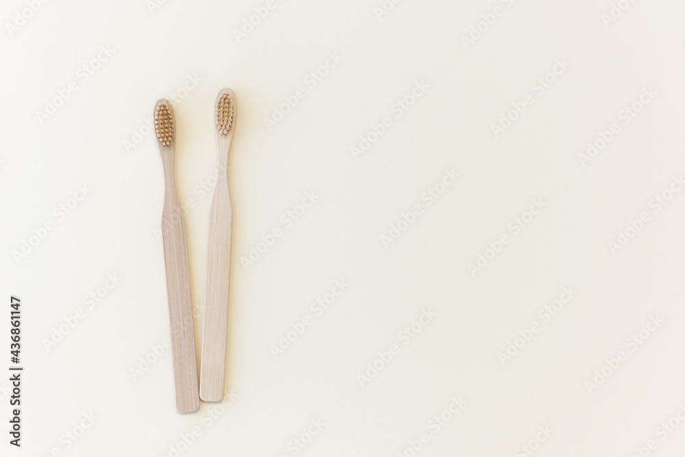 Eco-friendly bamboo toothbrushes on a beige background. Natural organic bathroom beauty product concept. Flat lay, top view, copy space Eco-friendly bamboo toothbrushes on a beige background. Natural organic bathroom beauty product concept. Flat lay, top view, copy space