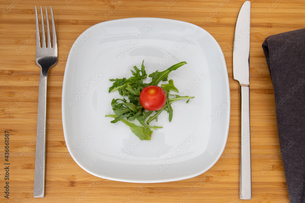 little portion salad on a plate little portion salad on a plate