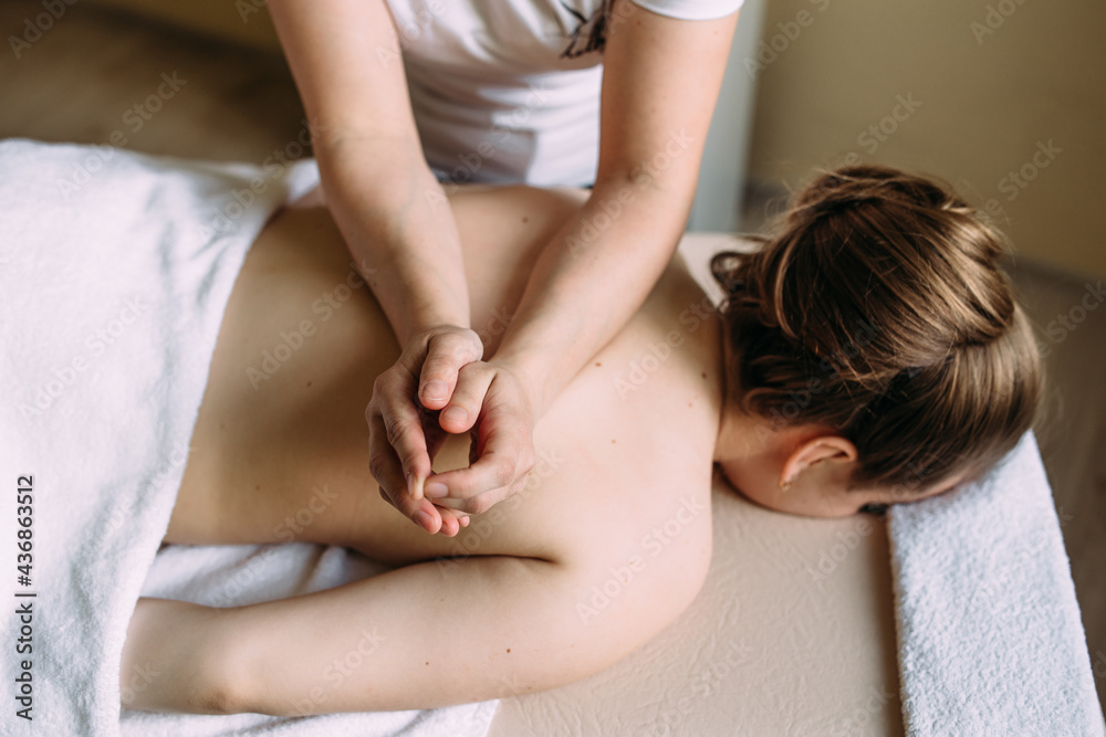 Massage therapist doing massage on the female body in the spa. Massage therapist doing massage on the female body in the spa.