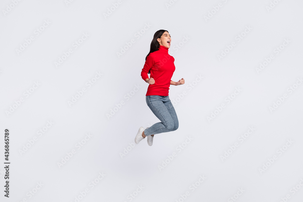 Full size photo of happy excited good mood woman jumping screaming in victory isolated on grey color background