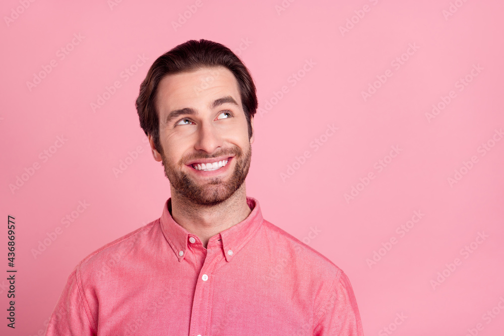 Fototapeta premium Photo of attractive young happy man look empty space dream news plan isolated on pastel pink color background