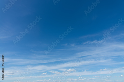Blue sky with light clouds background, natural sunny day sky replacement photo
