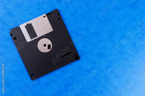 Floppy disk isolated on blue background. Retro computer diskette