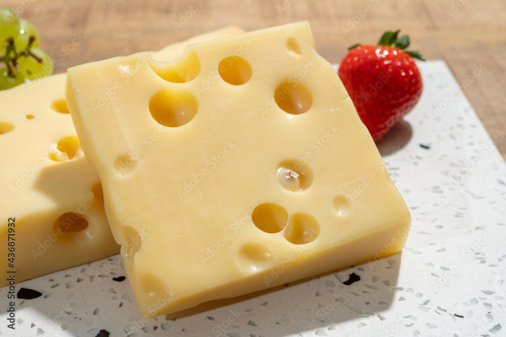 Cheese collection, blocks of French emmentaler cheese with many round holes made from cow milk Cheese collection, blocks of French emmentaler cheese with many round holes made from cow milk