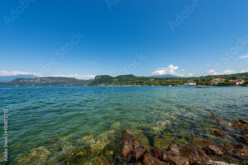 Lake Garda (Lago di Garda), beautiful bay in front of the small village of Bardolino, tourist resort in Verona province, Veneto, Italy, southern Europe. In the center the hill called Rocca di Garda.