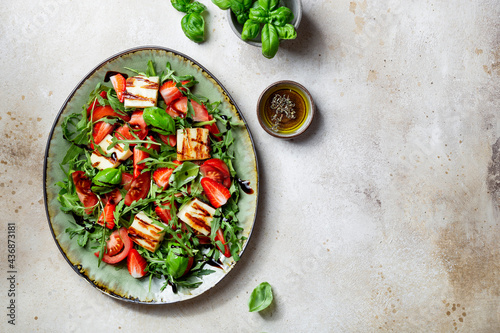 salad with strawberries, tomatoes and halloumi cheese