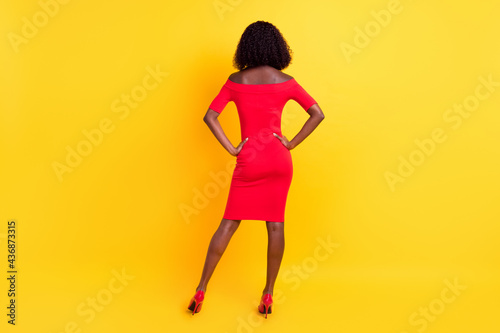 Full length photo of sexy back dark skin lady dressed red outfit arms waist isolated yellow color background