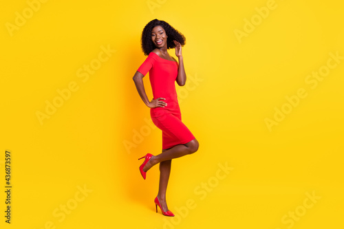Full length body size view of attractive thin cheerful girl dancing having fun isolated over bright yellow color background