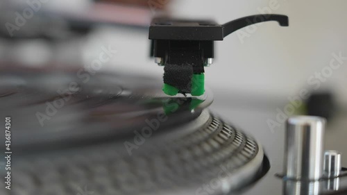 The headshell of the turntable going down to the platter  photo