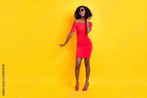 Full body photo of excited charming dark skin lady partying have fun isolated on yellow color background
