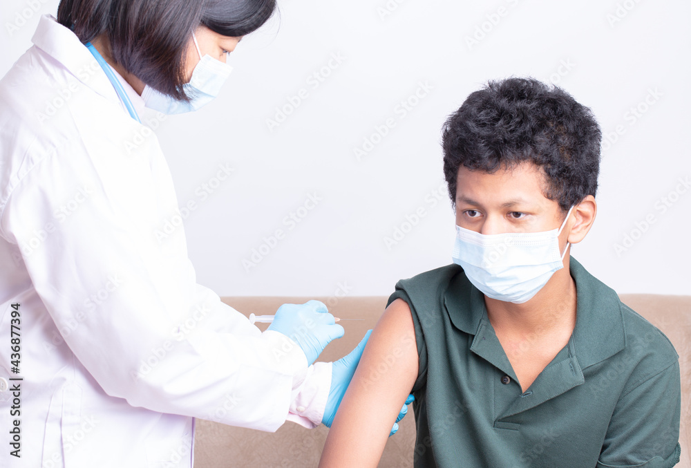 Medical care,woman doctor getting vaccine, doctor or nurse giving syringe shot to arm's patient. Vaccination, immunization, disease prevention against flu or virus pandemic business medical concept.