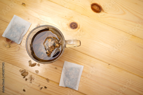 A mug of tea with a bag floating inside