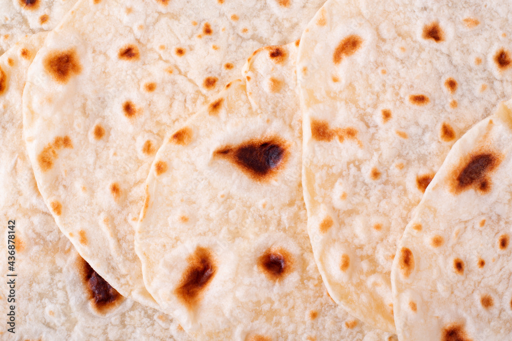 Tortilla flatbreads overlaping. Full frame background. Mexican food