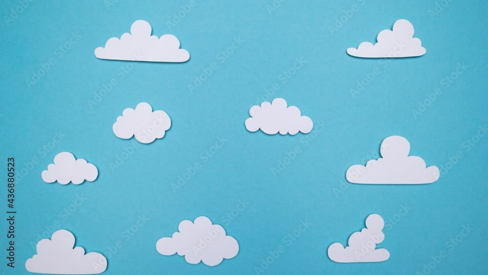 Stop Motion Animation. Paper cut out balloons floating through a blue sky and fluffy white clouds Stop Motion Animation. Paper cut out balloons floating through a blue sky and fluffy white clouds