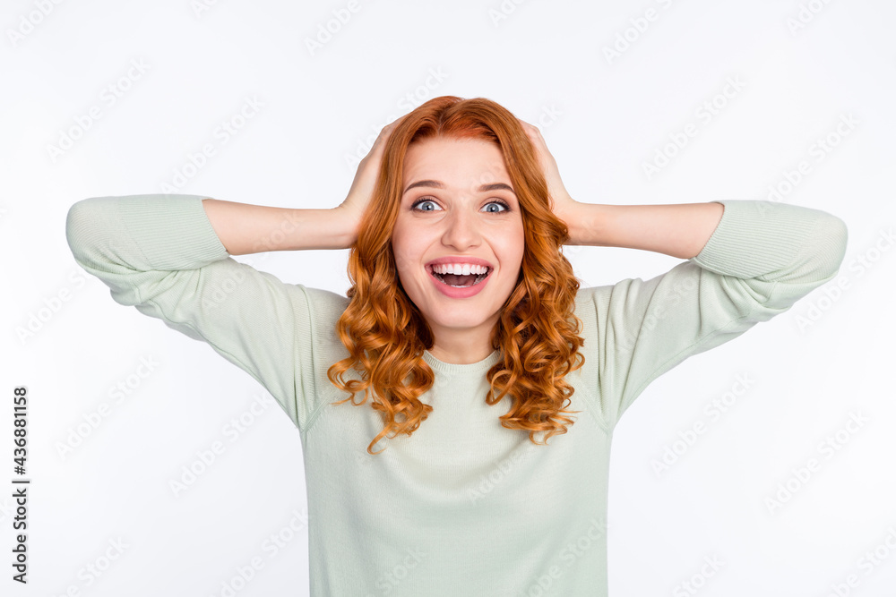 Photo portrait of red haired woman keeping head amazed wearing green jumper isolated white color background Photo portrait of red haired woman keeping head amazed wearing green jumper isolated white color background