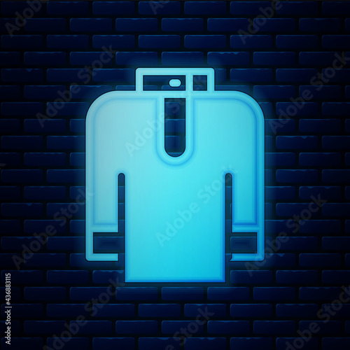 Glowing neon Shirt kurta icon isolated on brick wall background. Vector
