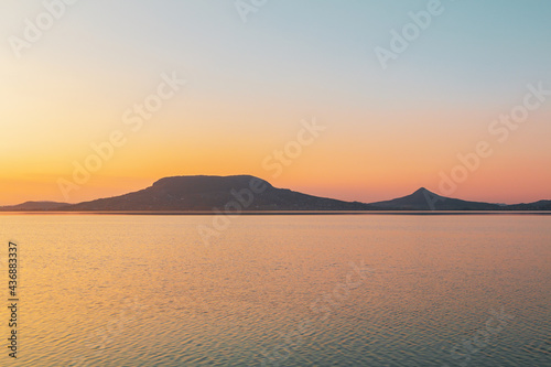 Beautiful panorama of Lake Balaton near the town of Fonyod, in the background the Badacsony Mountains and Szigliget at sunset photo