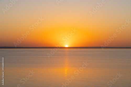 Horizontal line of calm sea at sunset