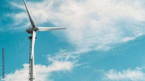 Wind turbine set against sky
