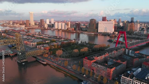 Beautiful drone video of the skyline of Rotterdam during sunrise. Bridges connecting the different sides of the city.