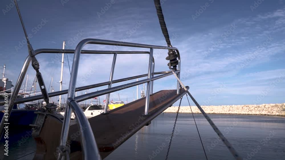 A sailing yacht out of the pot to the ocean on a sunny day. A sailing yacht out of the pot to the ocean on a sunny day.