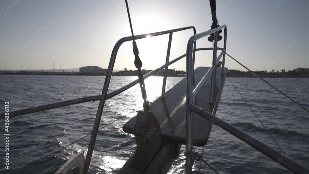 A sailing yacht evening cruising on the ocean on a sunny day, Larnaca Cyprus, handheld slowmotion A sailing yacht evening cruising on the ocean on a sunny day, Larnaca Cyprus, handheld slowmotion
