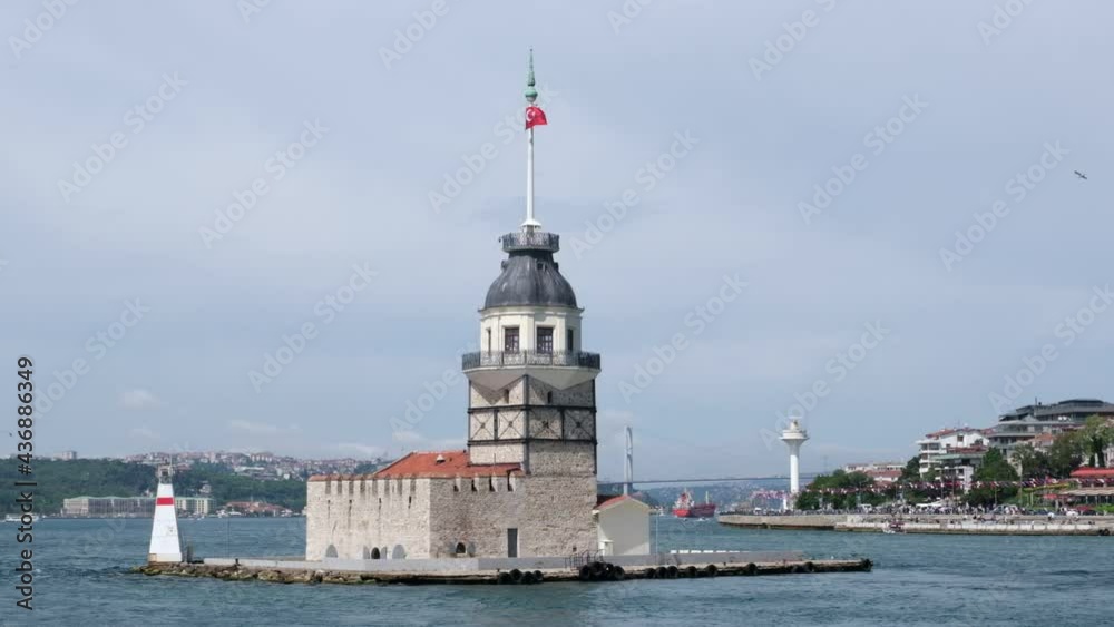 Historical Maiden's Towers at Istanbul from a ferry on the move in slow motion. The Bosphorus Bridge and a big radar tower are visible at the background. Historical Maiden's Towers at Istanbul from a ferry on the move in slow motion. The Bosphorus Bridge and a big radar tower are visible at the background.
