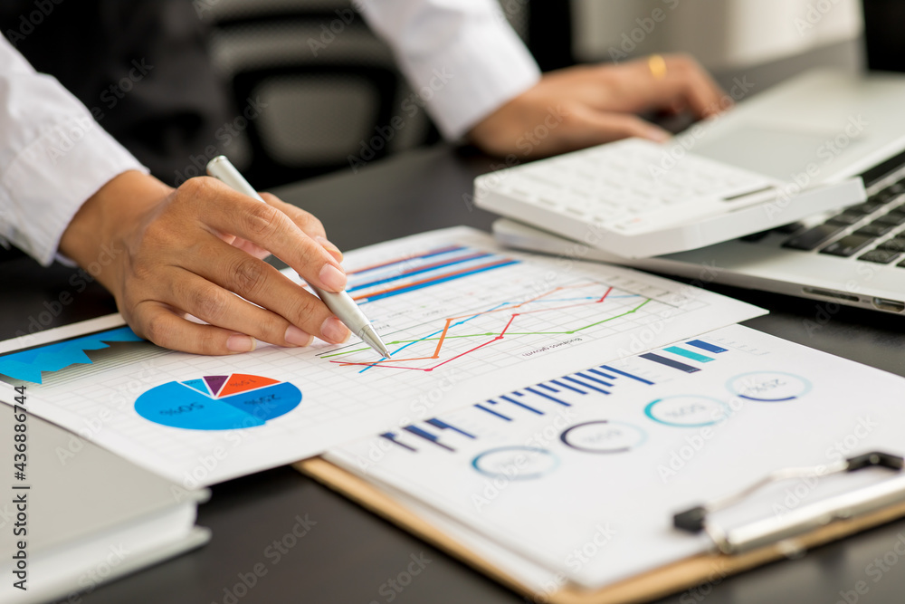 Financial Businesswomen analyze the graph of the company's performance to create profits and growth, Market research report and income statistics, Financial and Accounting concept.