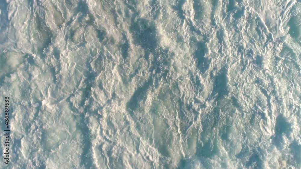 Ocean waves close-up, white foam from the waves of the raging ocean water. Ocean waves close-up, white foam from the waves of the raging ocean water.