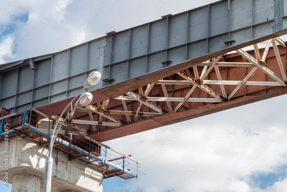 close-up view of railway bridge under construction. connection of steel powerful straight crossbar, bridge connection, metal architecture