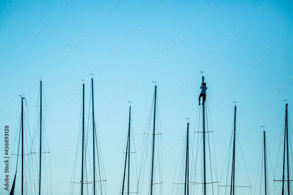 Person working on a sailboat.