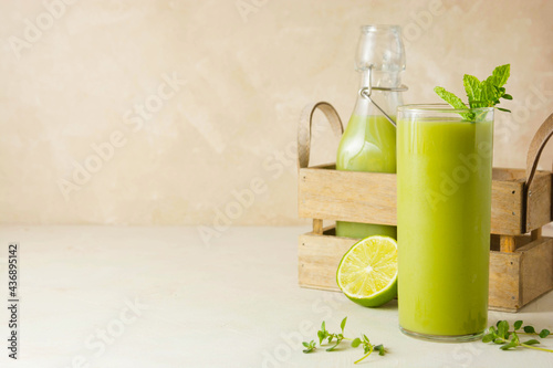 Detox concept. Healthy smoothie glass with fresh spinach, banana, pineapple. Delicious homemade green drink. Copy space