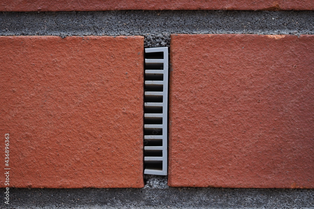 Fototapeta premium ventilation plastic insert in a brick wall