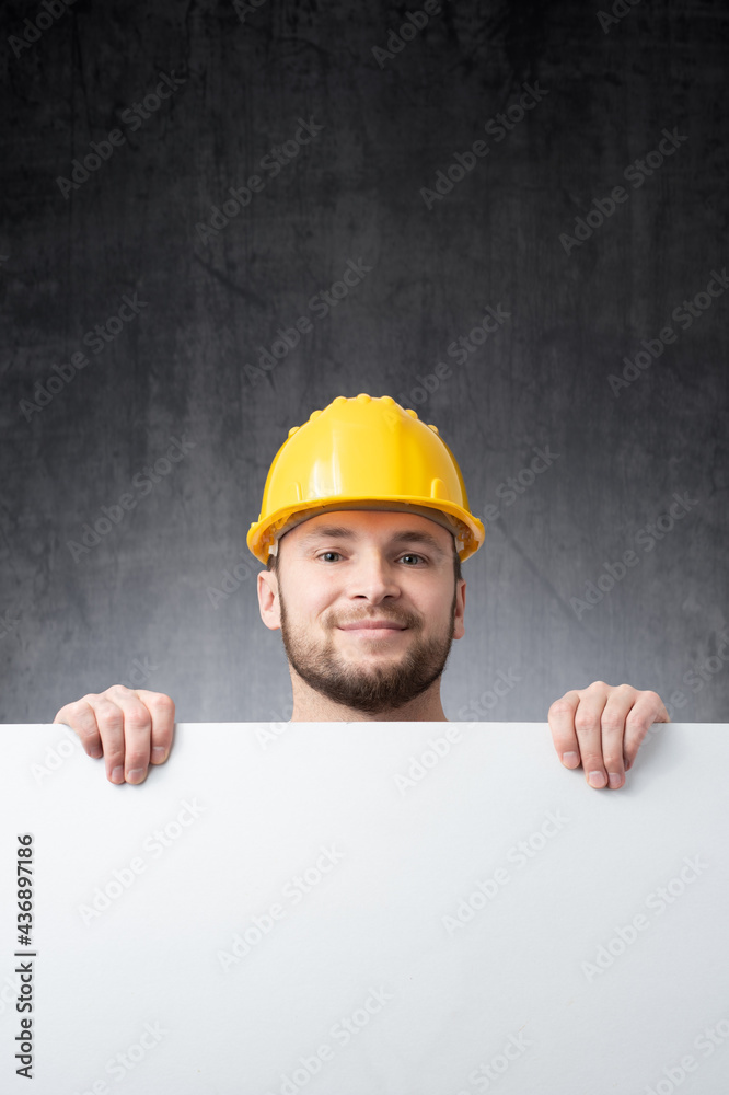 Worker holding a blank board Worker holding a blank board