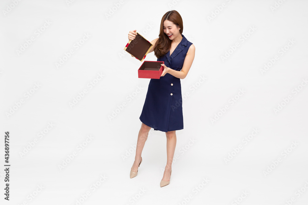 Portrait of a happy smiling Asian woman opening a gift box isolated on white background Portrait of a happy smiling Asian woman opening a gift box isolated on white background