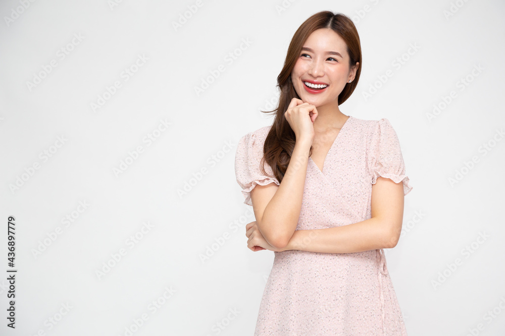 Close-up portrait of a smiling charming Asian woman looking to empty space and thinking creative isolated on white background Close-up portrait of a smiling charming Asian woman looking to empty space and thinking creative isolated on white background