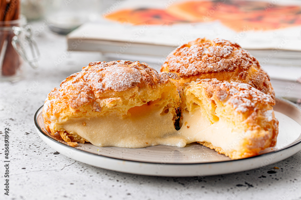 Fresh baked choux pastry cakes with cream filling Fresh baked choux pastry cakes with cream filling